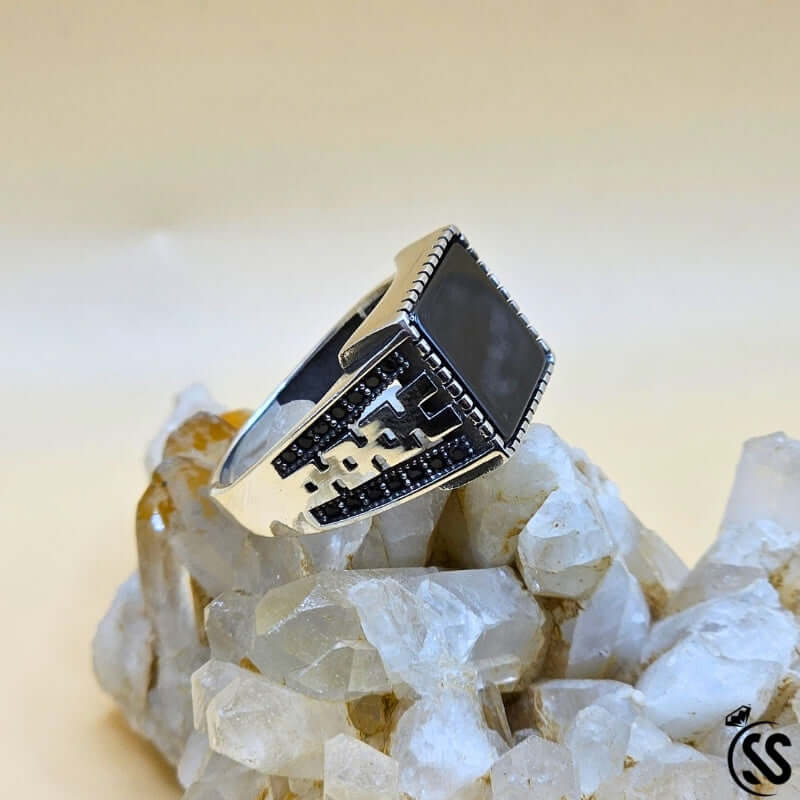 Vintage Turkish 925 sterling silver gents ring with black stone on quartz crystal backdrop.