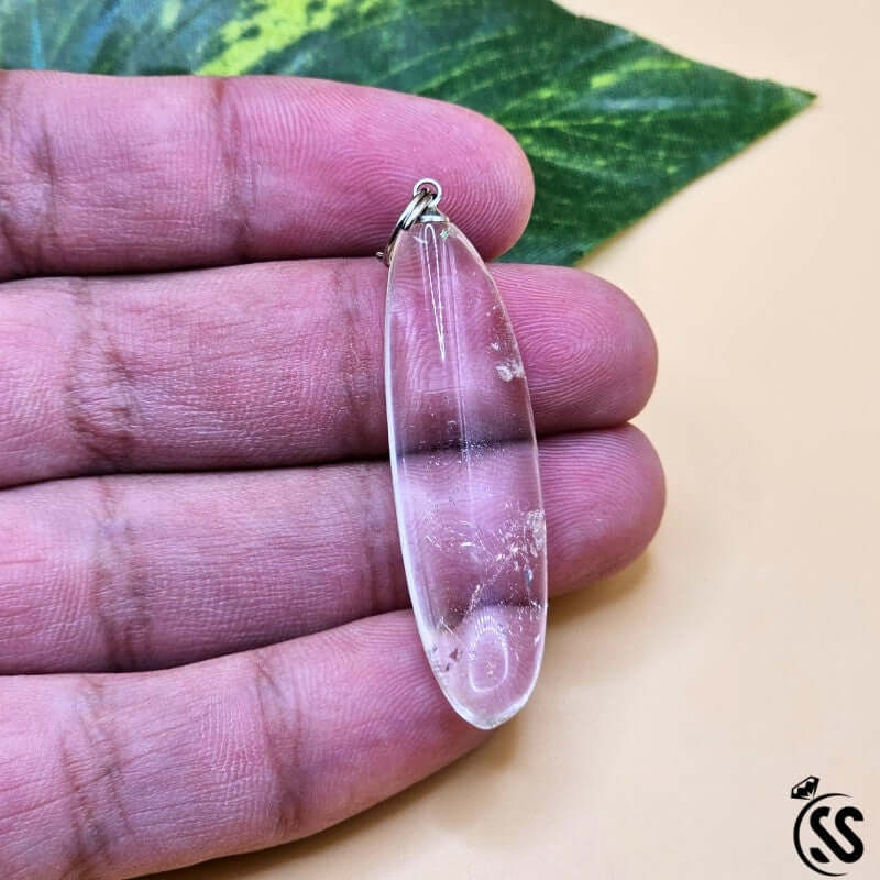 Clear Quartz Real Stone Pendant held in hand, showcasing natural crystal beauty and clarity.
