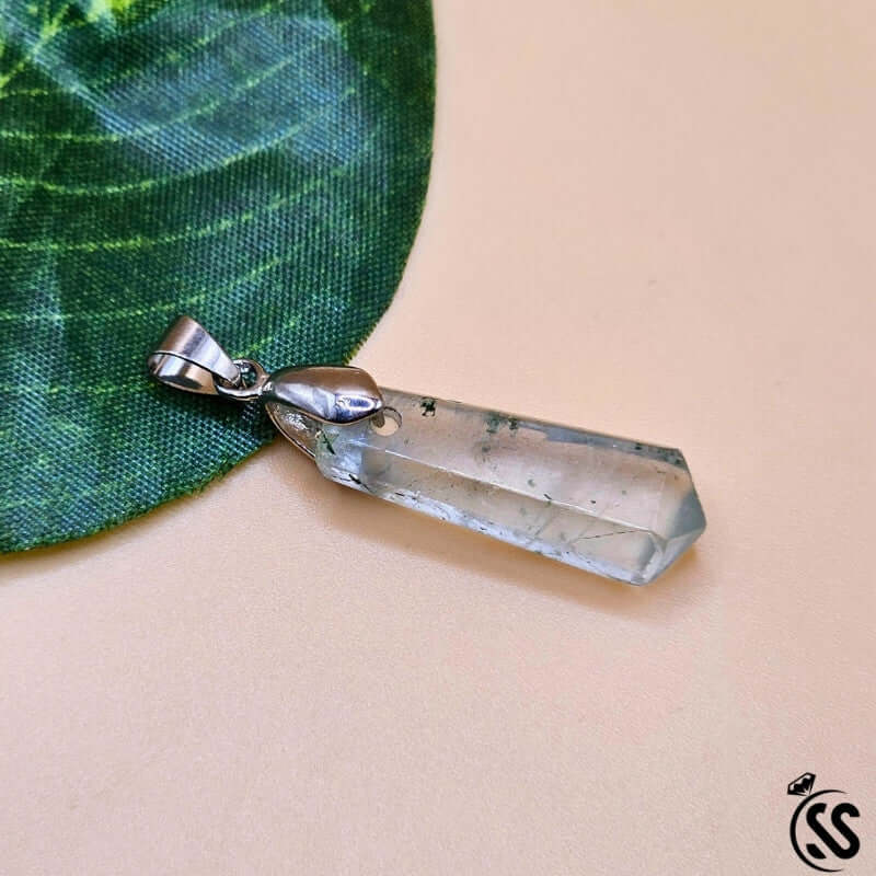 Fluorite real stone pendant on green leaf, symbolizes clarity, focus, and protection.