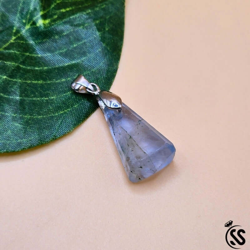 Fluorite real stone pendant showcasing unique colors for clarity, focus, and protection on a green leaf background.