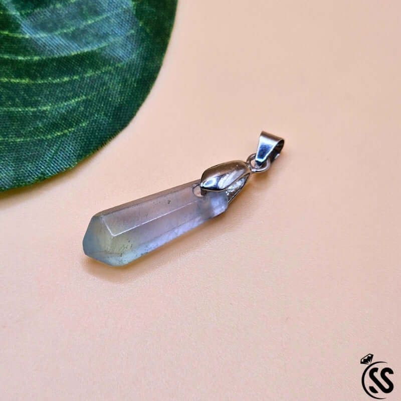 Fluorite real stone pendant showcasing its natural clarity and color, perfect for mental focus and spiritual protection.