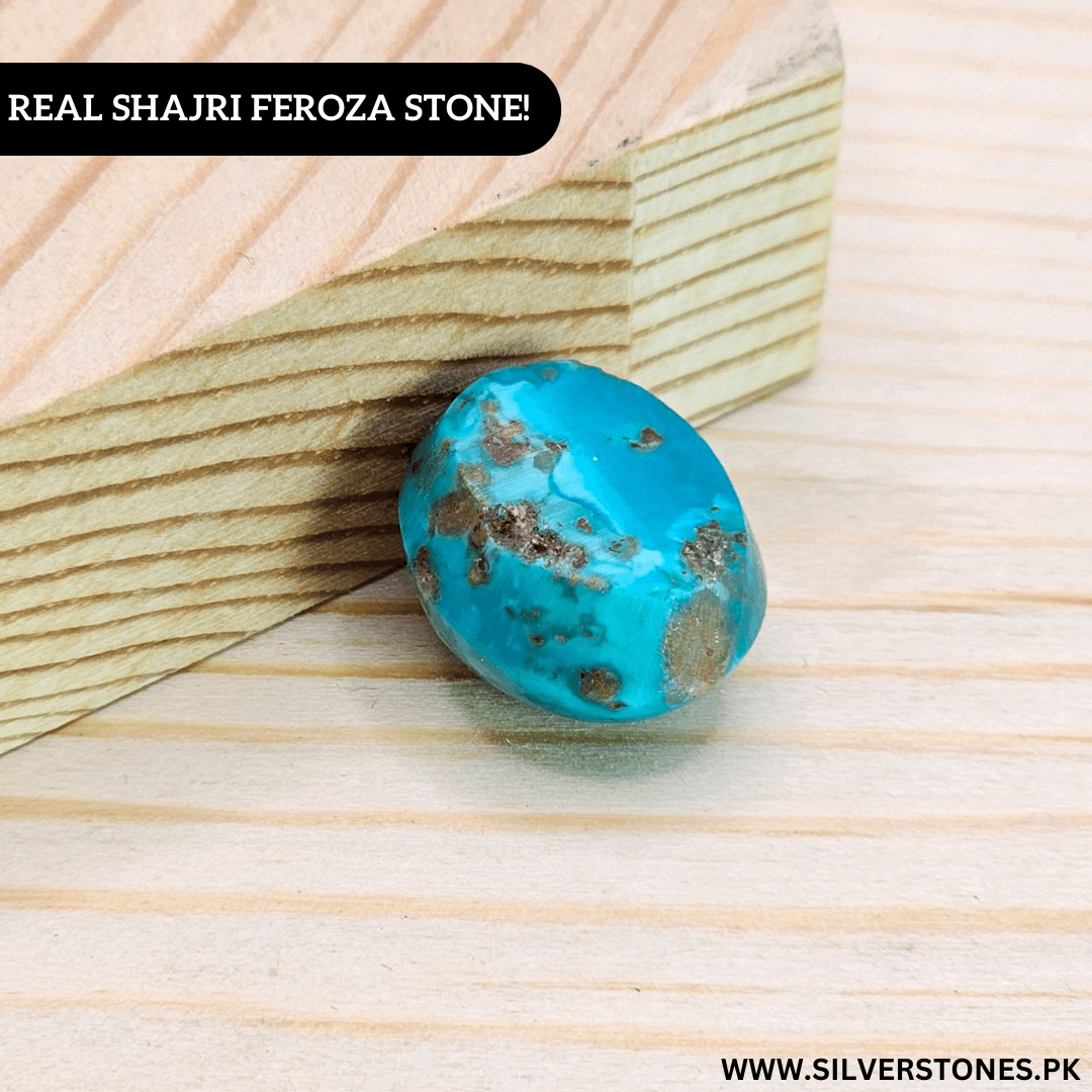 Authentic Shajri Irani Feroza stone in vibrant turquoise on wood background, showcasing its natural beauty.