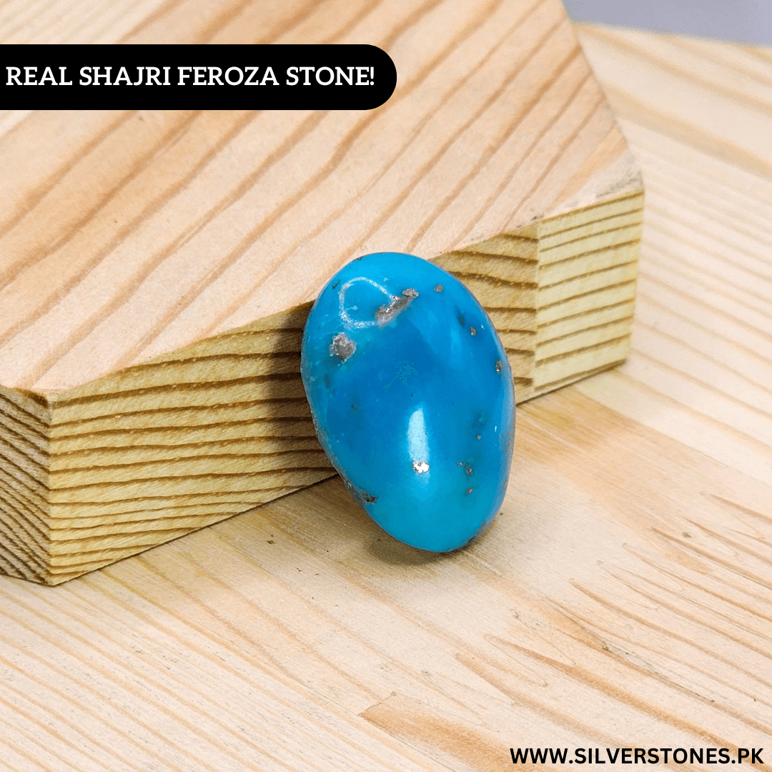 Real Shajri Irani Feroza stone in oval shape showcasing its vibrant turquoise color on a wooden base.
