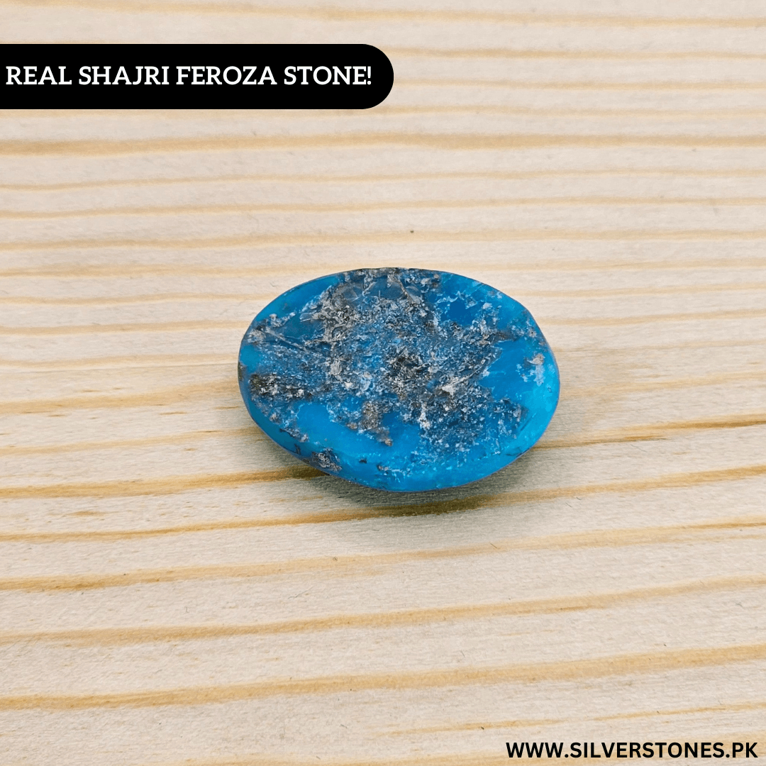 Authentic Shajri Irani Feroza stone, oval-shaped turquoise with natural beauty on wooden background.