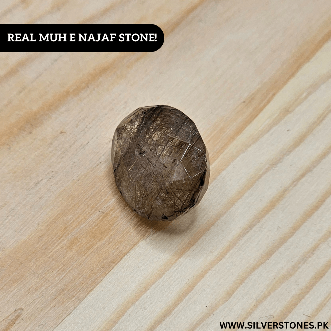 Authentic Golden Muh-e-Najaf stone showcasing its natural beauty and unique texture on a wooden surface.