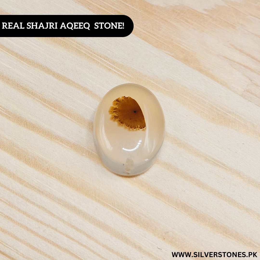 Real Shajri Aqeeq Stone showcasing unique patterns on a natural wooden background.