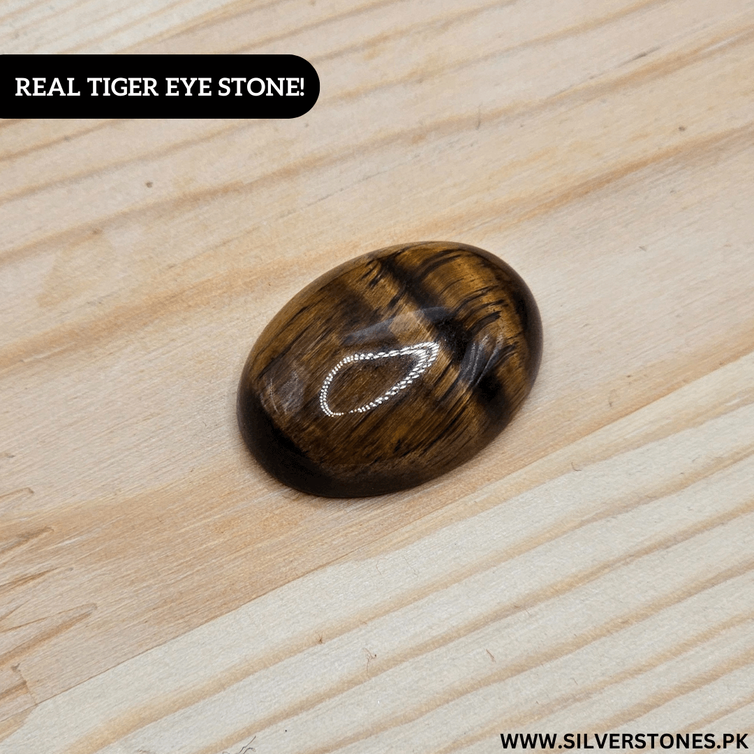 Real Tiger Eye Stone showcasing its golden and brown hues on a wooden surface, symbolizing strength and protection.