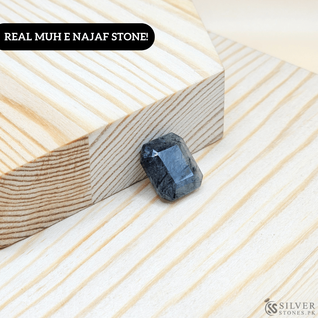 Real Muh-e-Najaf stone displayed on wood, showcasing its round shape and natural clarity.