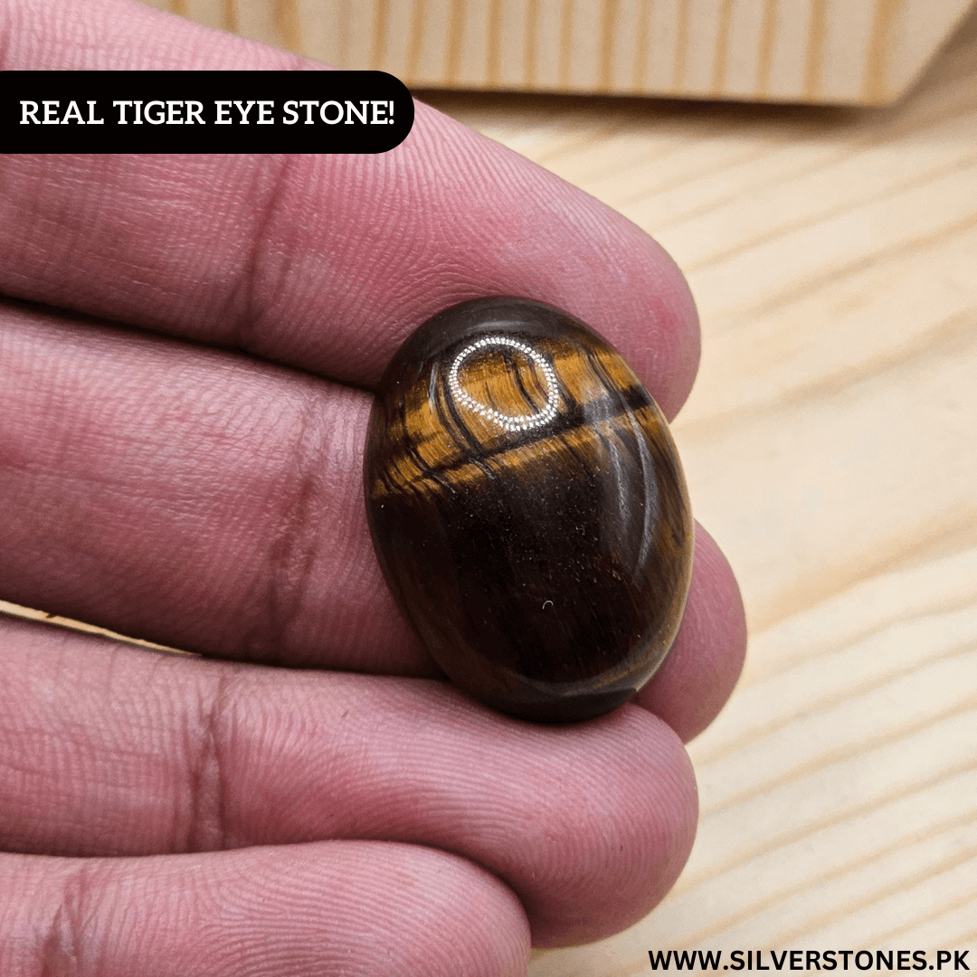 Authentic Real Tiger Eye Stone held in hand, showcasing its unique golden and brown hues.