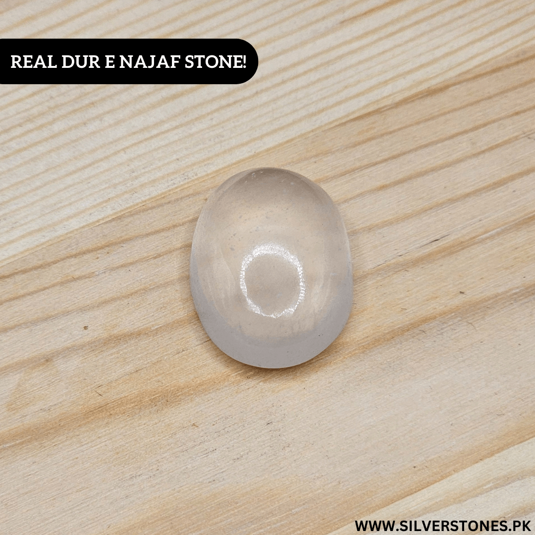 Real Dur-e-Najaf Stone on wooden surface highlighting its clarity and spiritual significance.