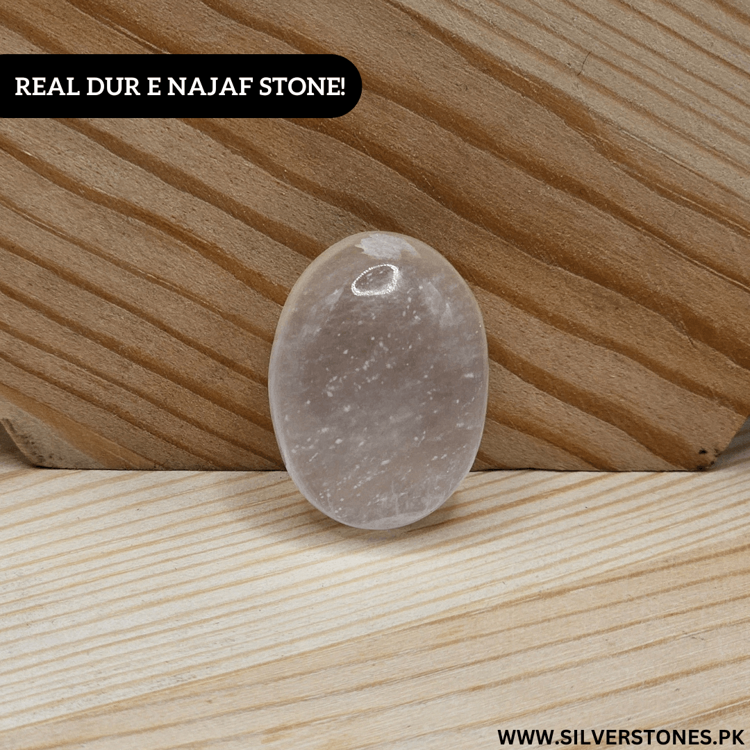 Real Dur-e-Najaf Stone displaying its pure transparency and elegance on a wooden surface.
