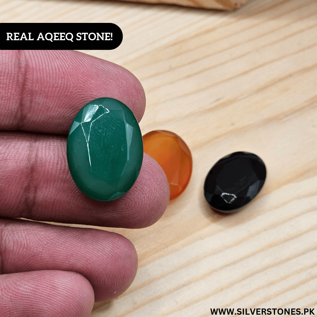 Hand holding a real Yamni Aqeeq stone, showcasing its vibrant green color and natural beauty.