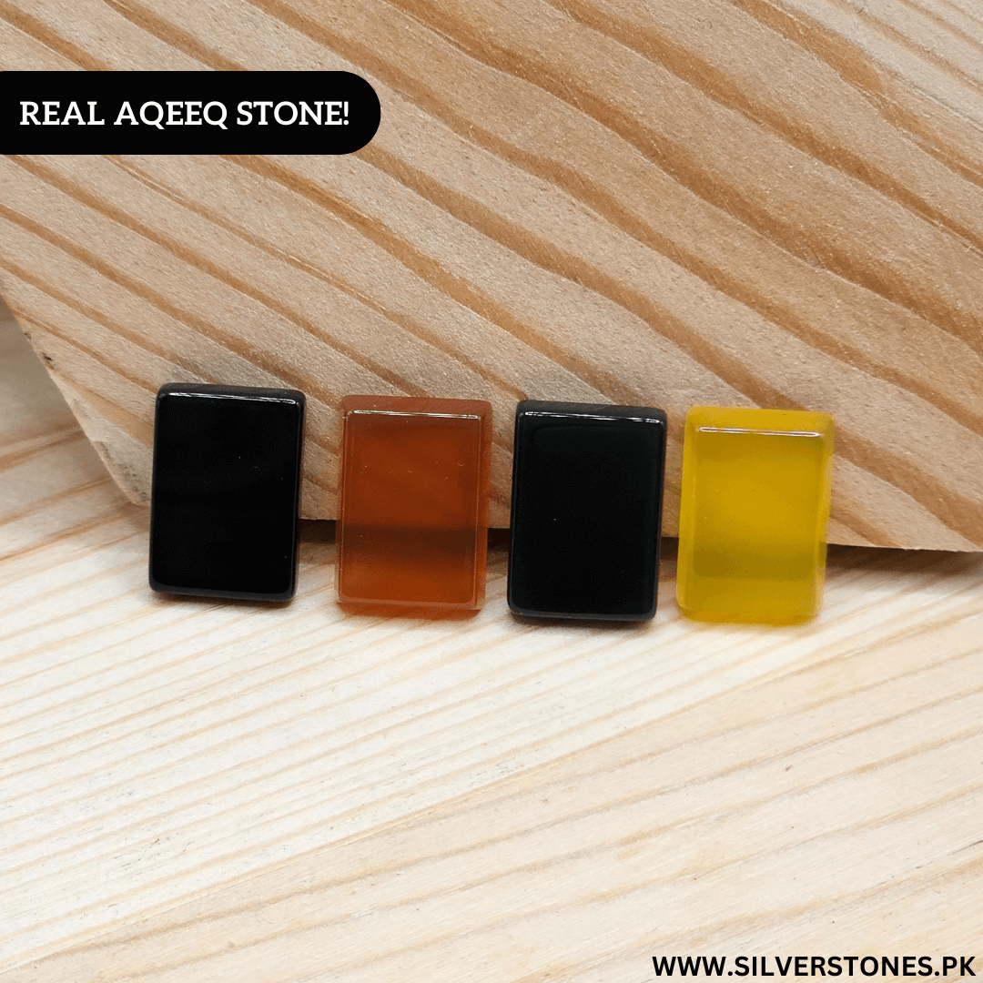 Four Real Yamni Aqeeq Stones in various colors displayed on wooden surface.