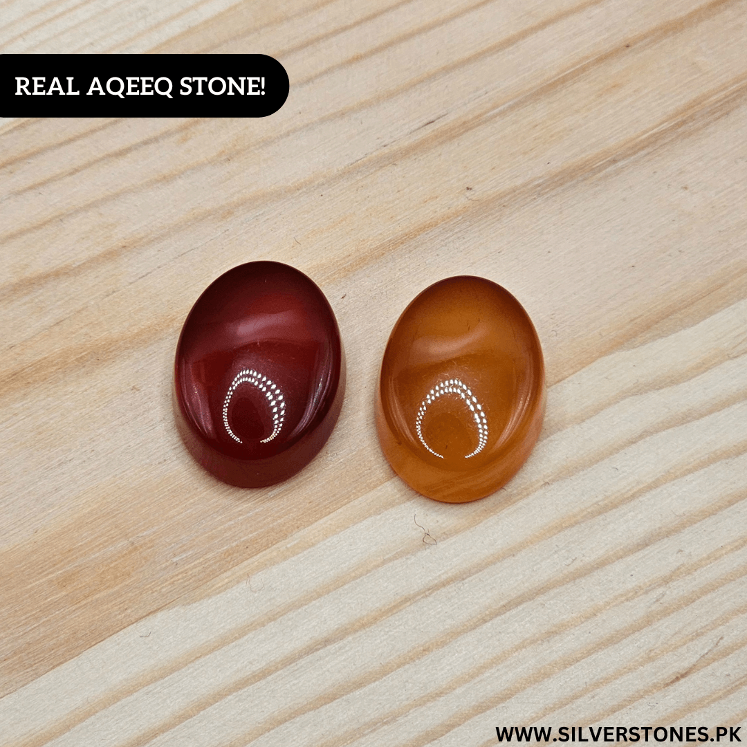 Real Yamni Aqeeq stones in red and orange on wooden background, showcasing their natural beauty and spiritual significance.