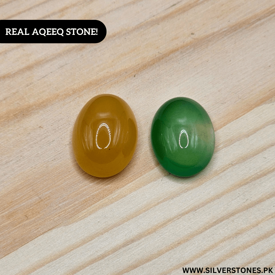 Real Yamni Aqeeq stones in yellow and green on wooden background, symbolizing spiritual power and protection.