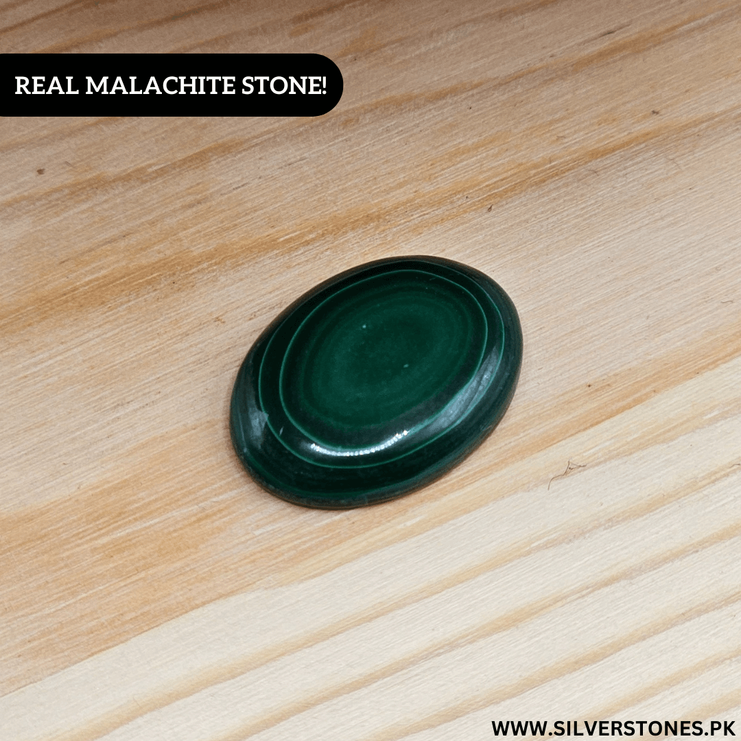 Real Malachite Stone on wooden surface, known for its vibrant green color and kidney health benefits.