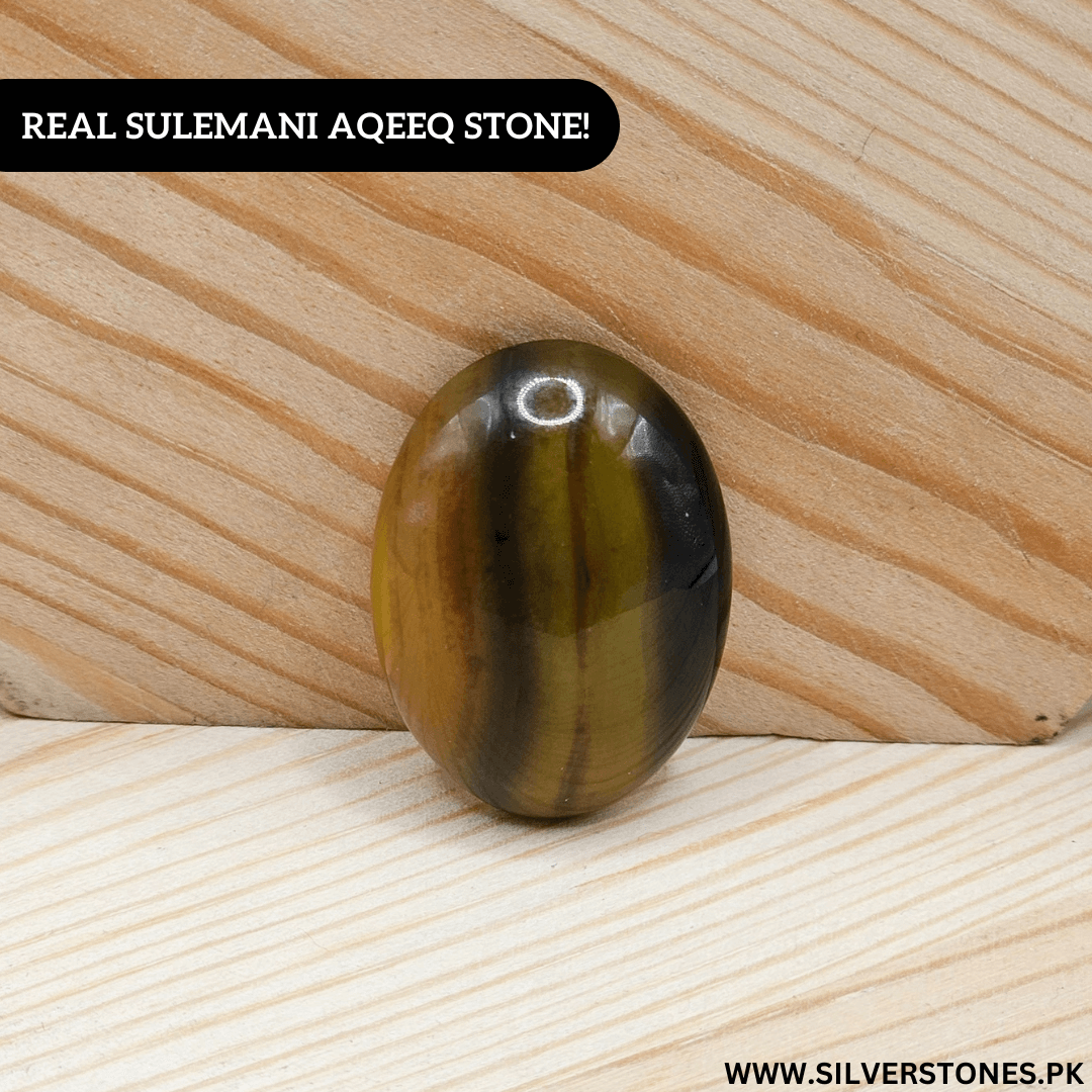 Real Sulemani Aqeeq Stone on wooden surface, symbolizing strength, protection, and serenity in jewelry.