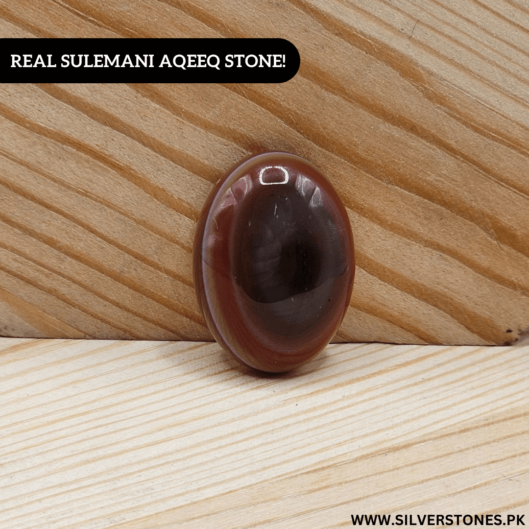 Real Sulemani Aqeeq Stone on wooden background, symbolizing strength and serenity.