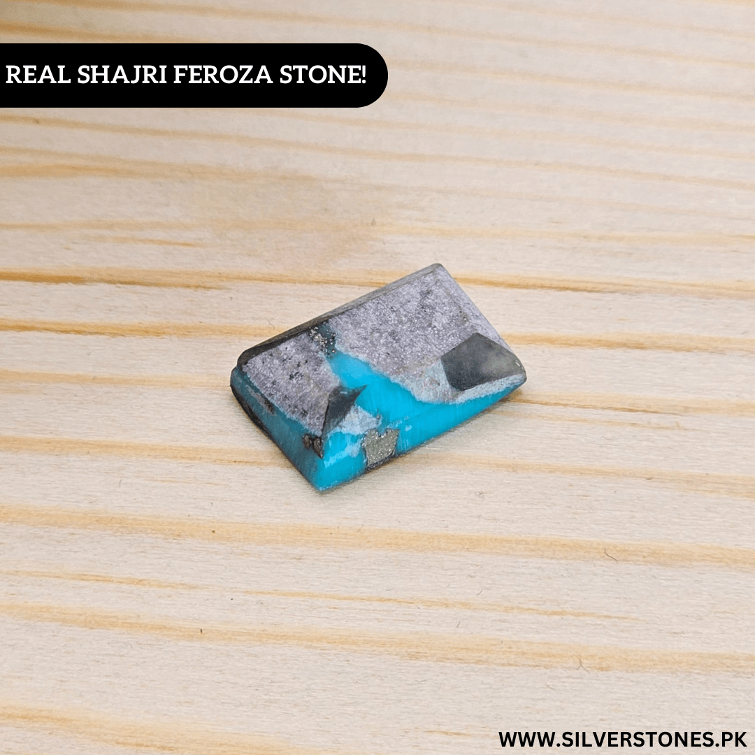 Real Shajri Feroza stone, a genuine turquoise piece in a unique rectangle shape on a wooden surface.