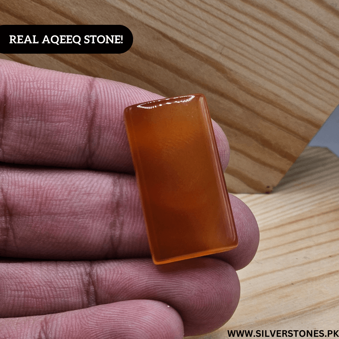 Hand holding a genuine Yamni Aqeeq stone, showcasing its rich color and natural beauty.