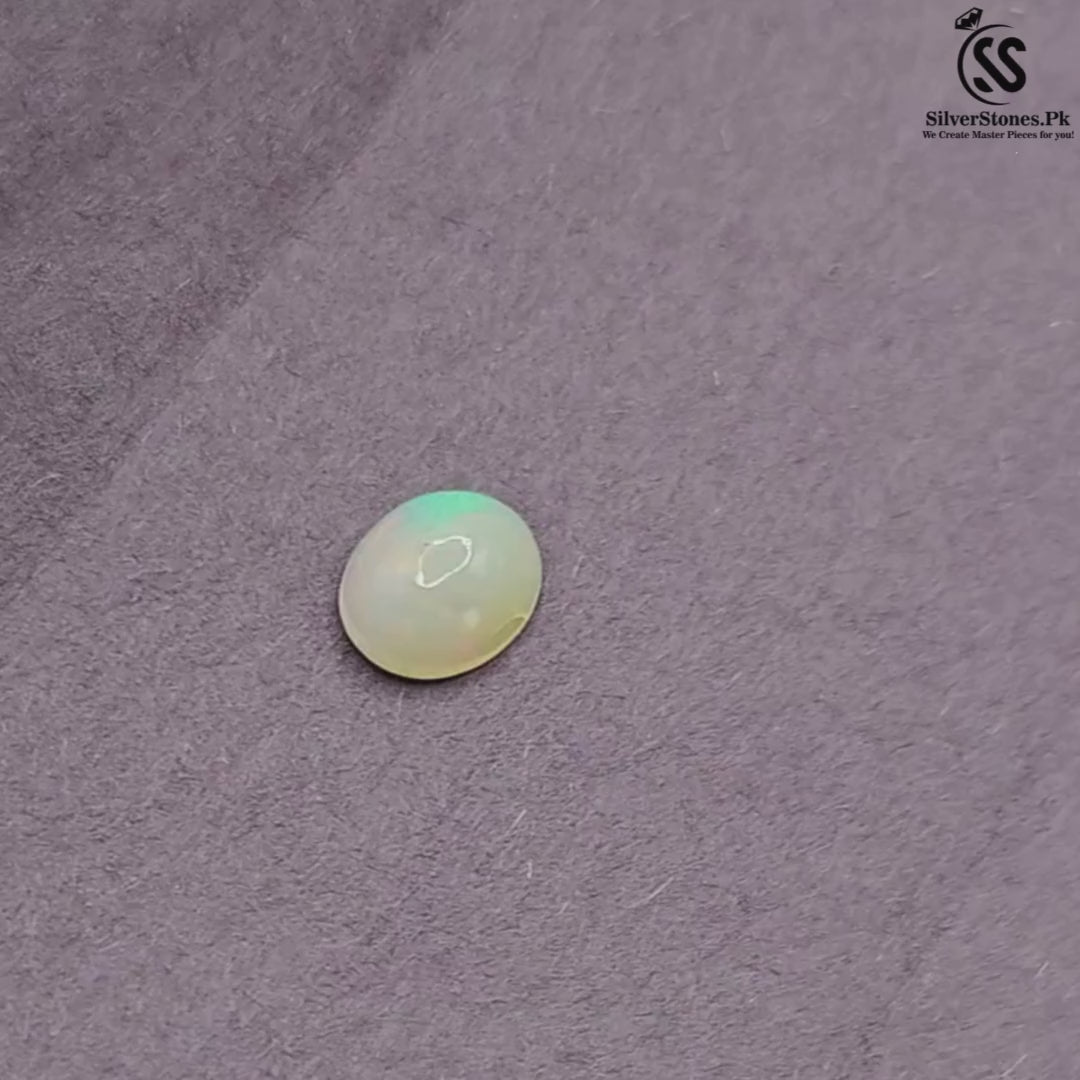 Real White Ethiopian Opal in oval shape showcasing vibrant play-of-color on a grey background.