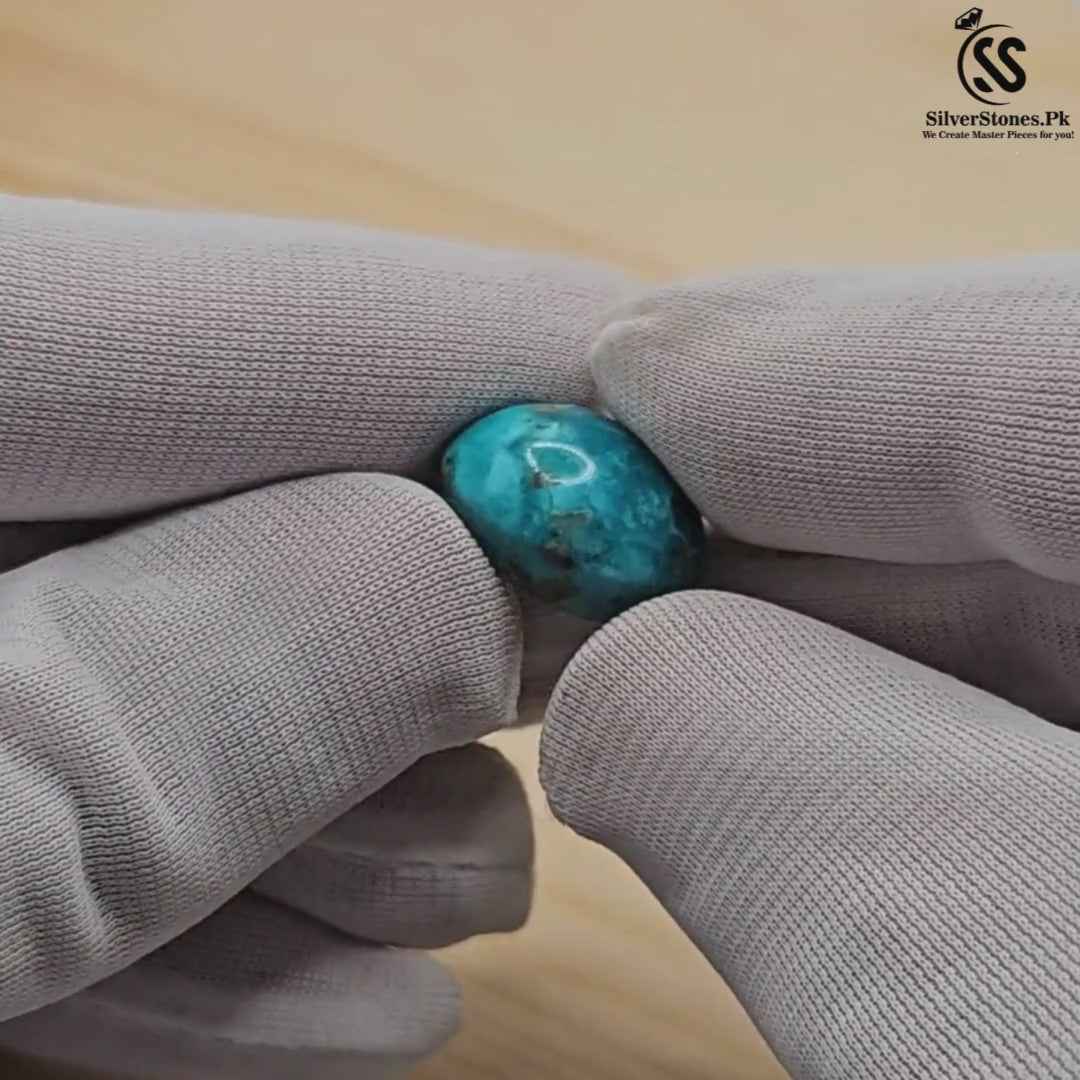 Hand holding a real Shajri Irani Feroza (Turquoise) stone, showcasing its vibrant color and natural beauty.