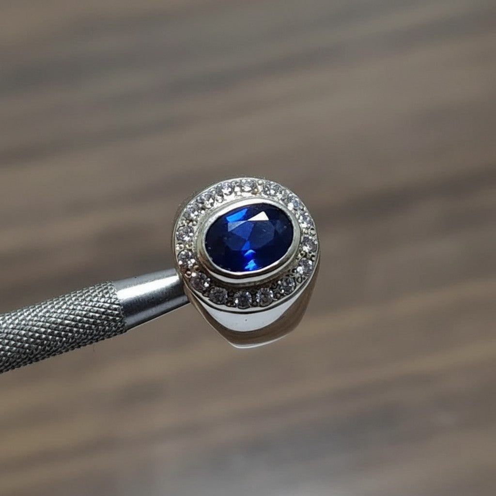 SilverStones.Pk men's oval blue sapphire ring with small clear stones around the setting. Authentic silver.