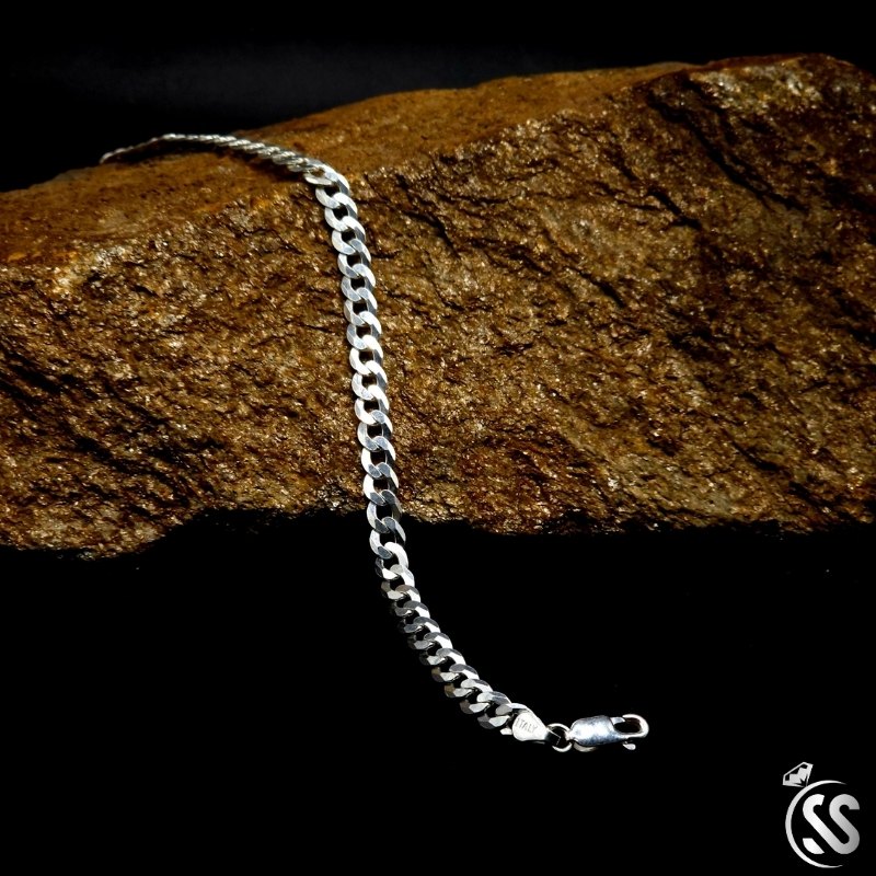 4mm Italian 925 sterling silver Cuban bracelet for men on a rock surface, showcasing elegance and durability.