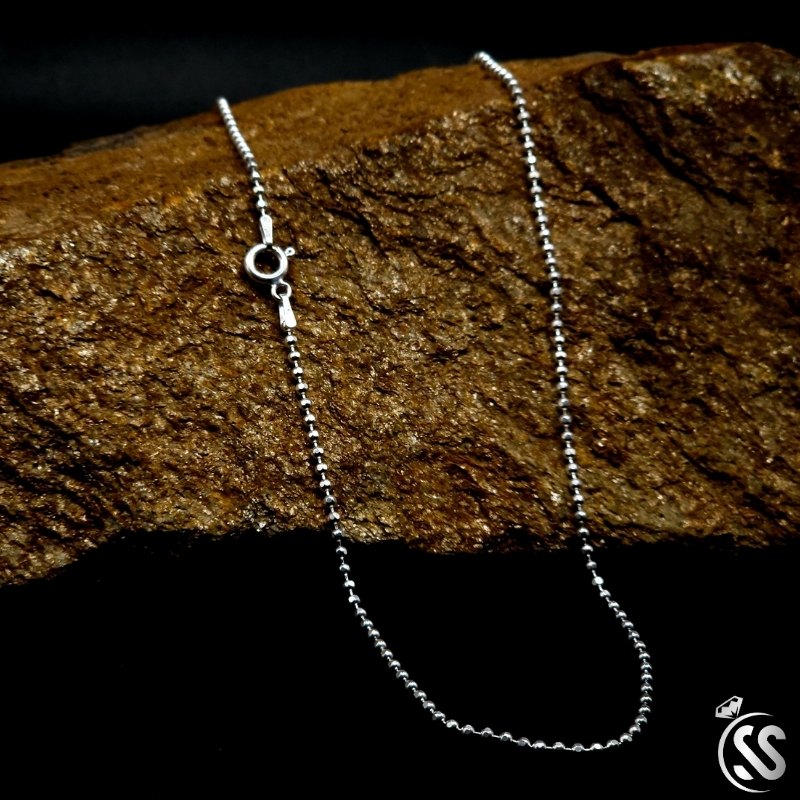 Italian Silver Sterling 925 ladies ball chain necklace, 2mm width, 22 inches long, displayed elegantly on a stone background.