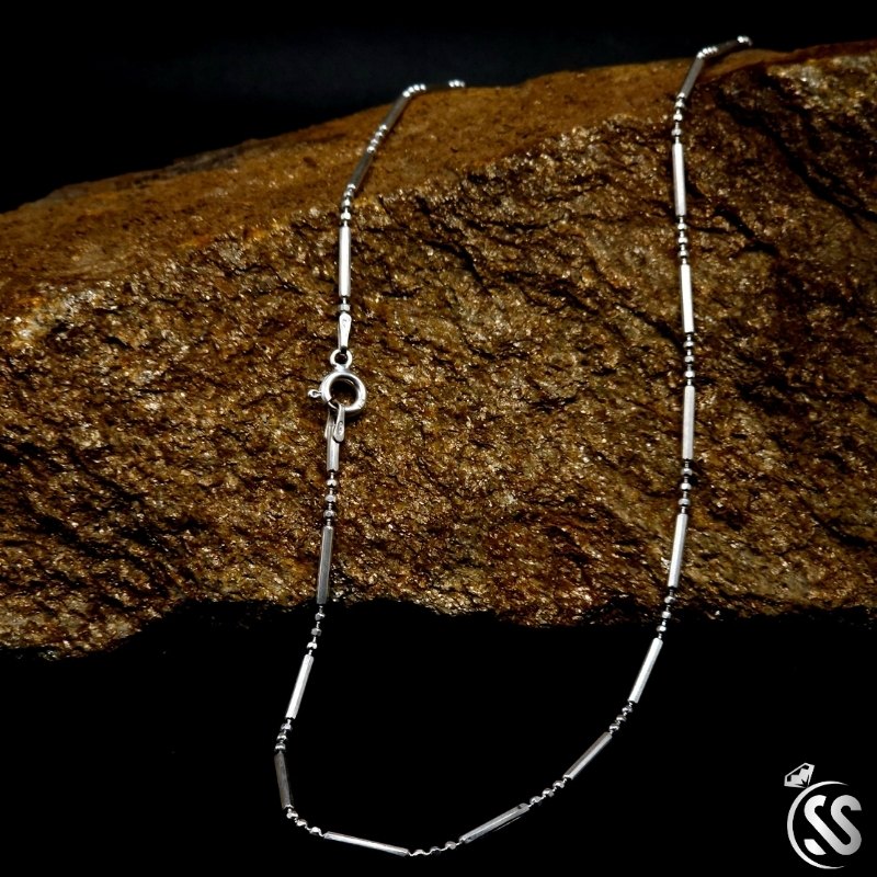 Italian sterling silver ladies chain elegantly displayed on textured stone, showcasing its timeless design.