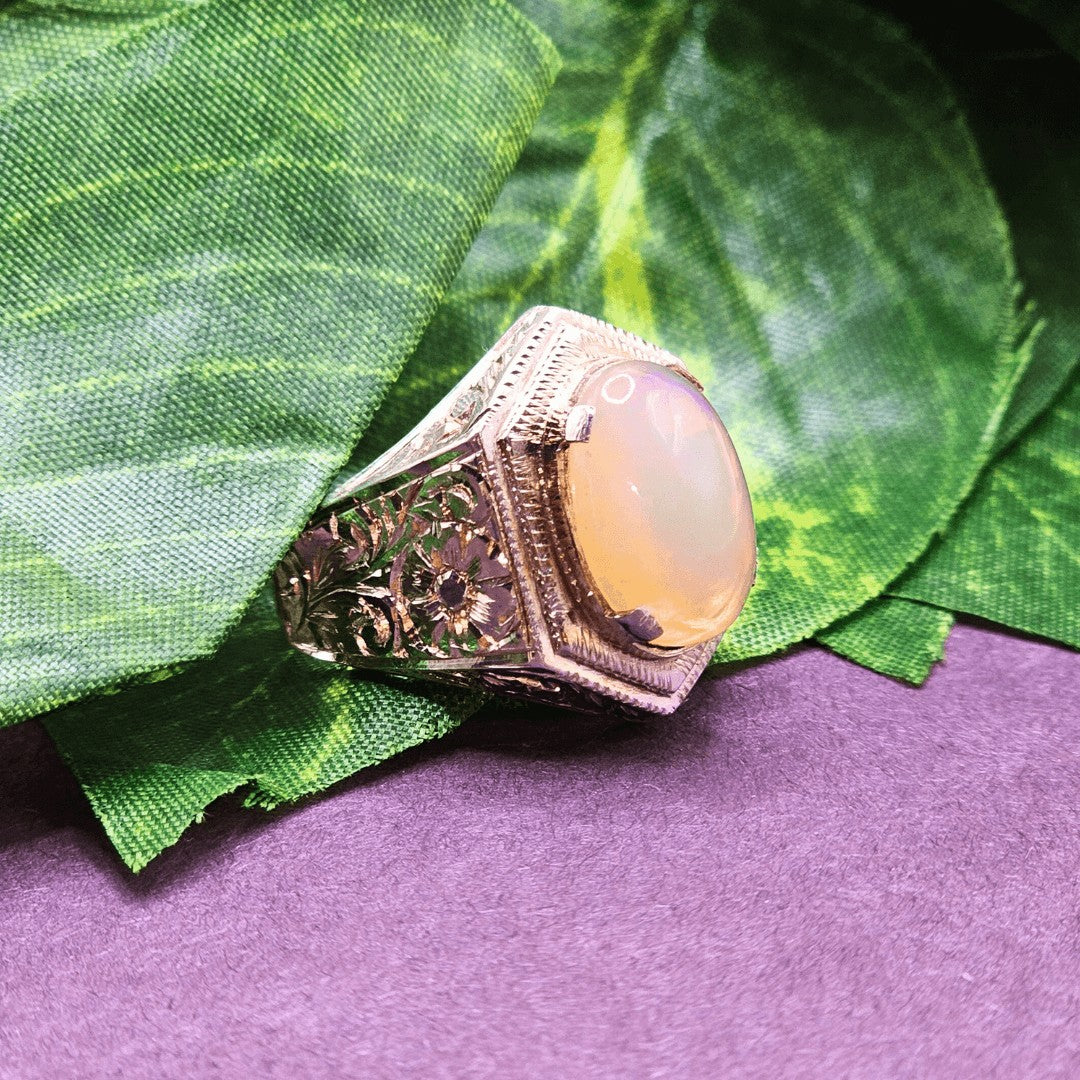 Close-up of natural Ethiopian opal gemstone set in a handcrafted engraved chandi ring.
