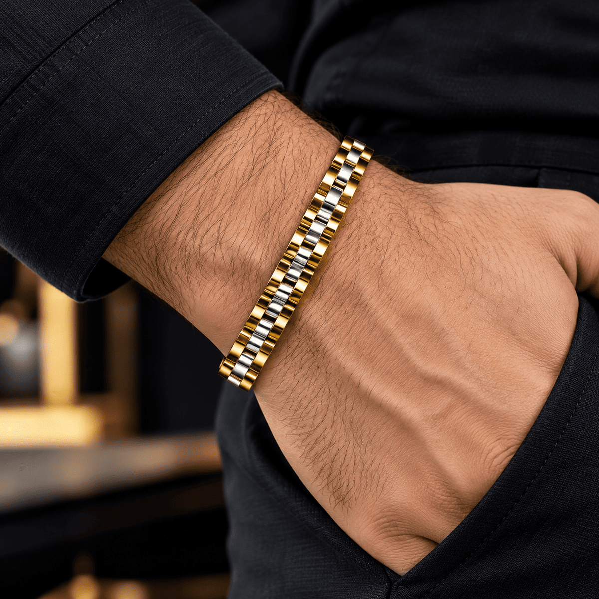 Close-up of the polished gold and silver links on a men’s two-tone bracelet.