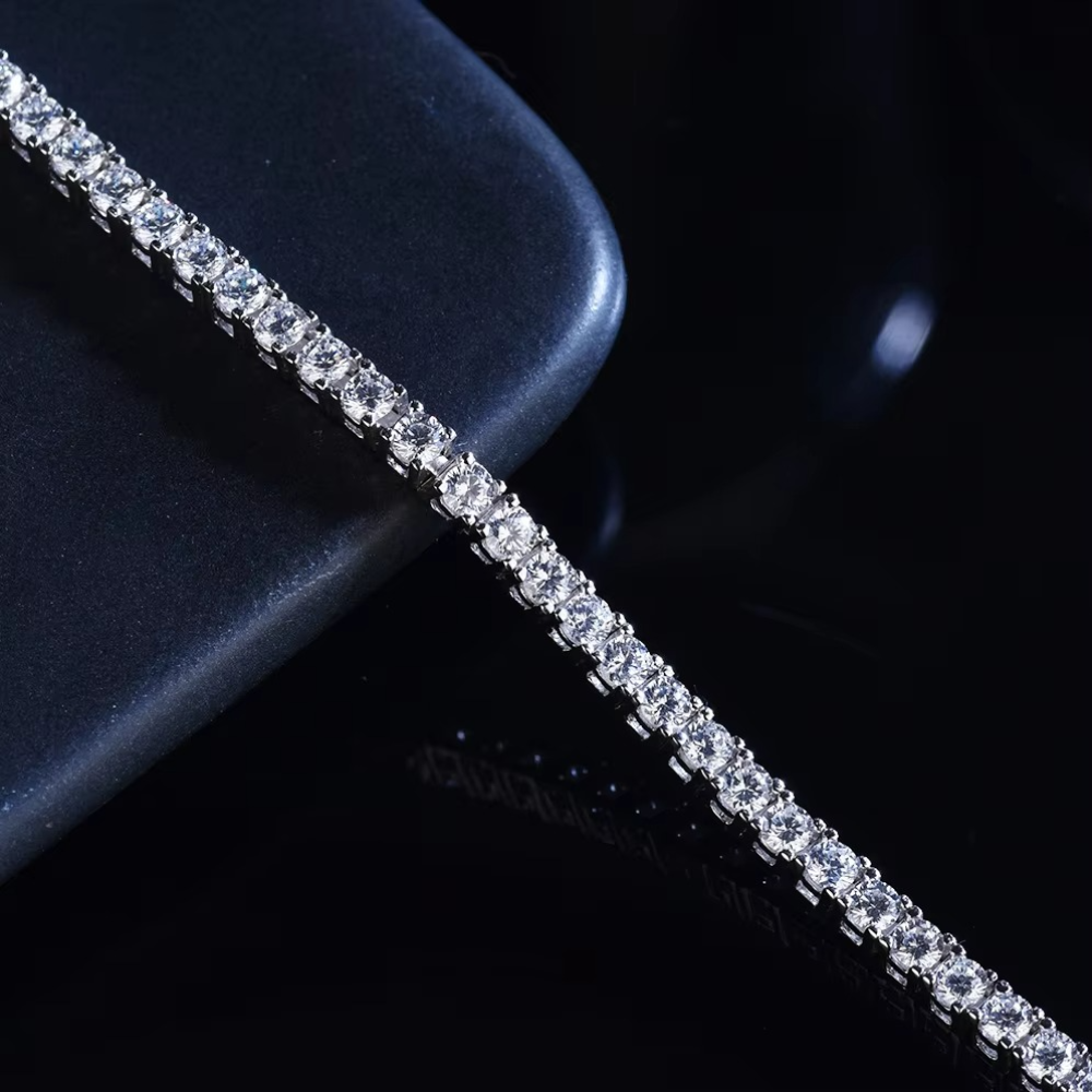 Elegant women’s tennis bracelet featuring 4mm moissanite diamonds and rhodium coated Italian silver.