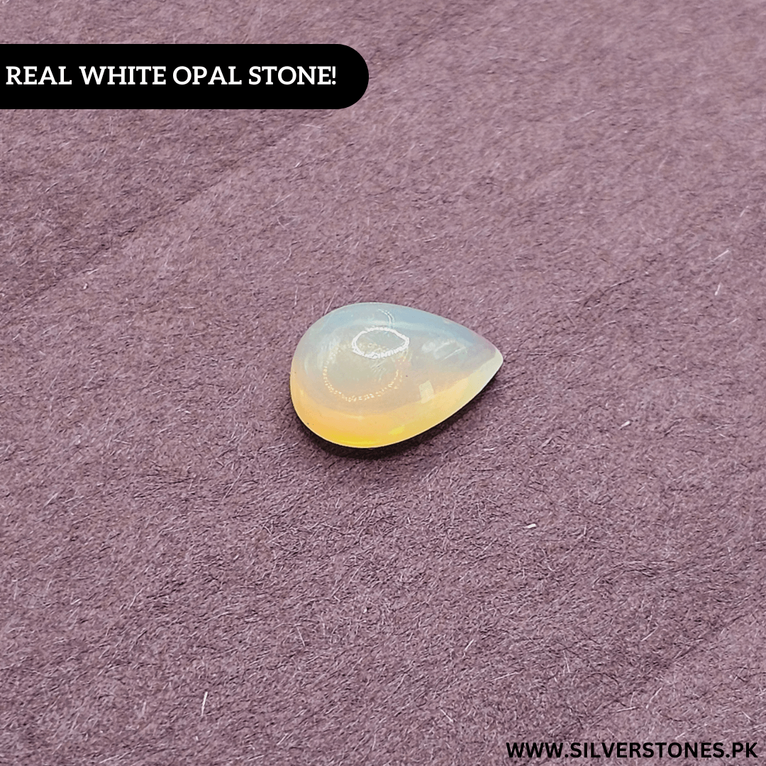 Real White Ethiopian Opal in pear shape showcasing stunning luminescent glow on a textured surface.