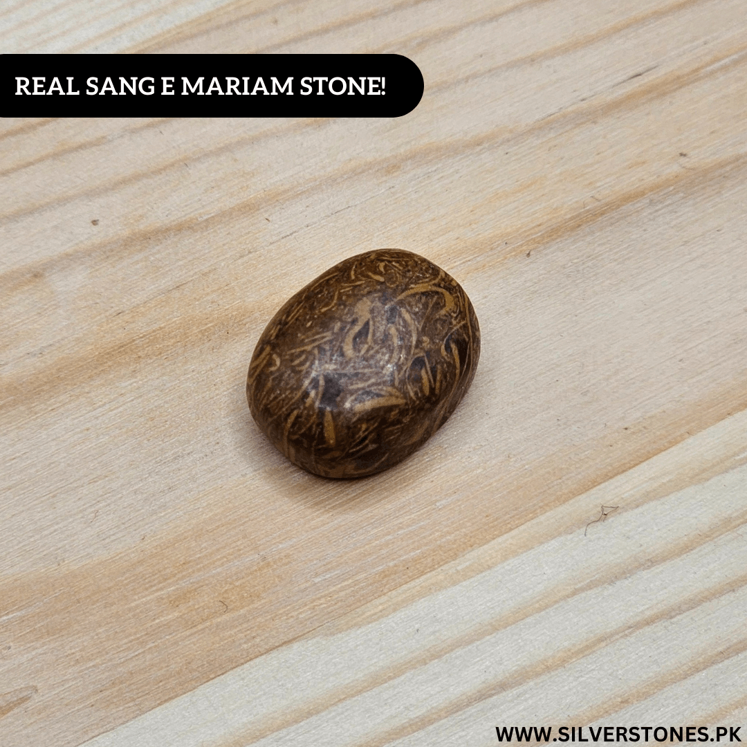 Real Sang-e-Mariam Stone on wooden surface, symbolizing purity and spiritual power.