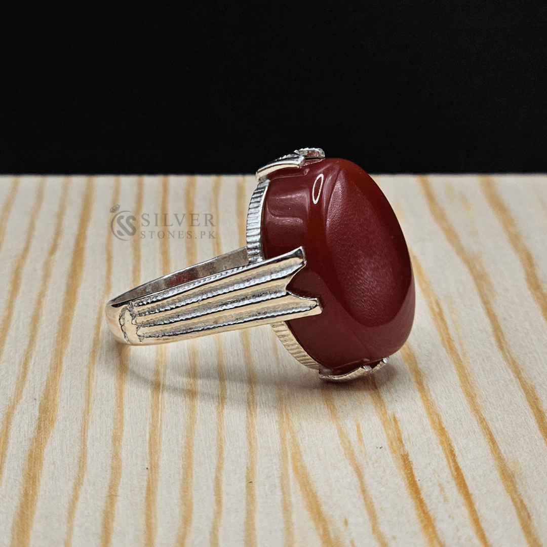 Real Aqeeq Silver ring showcasing a vibrant red gemstone, handmade with intricate silver detailing.