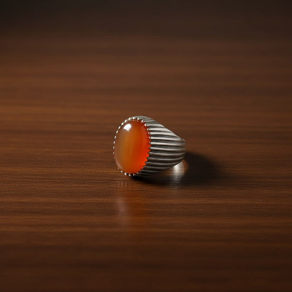SilverStones.Pk men's ring with oval carnelian gemstone and ribbed silver-tone band. Warm orange gemstone.