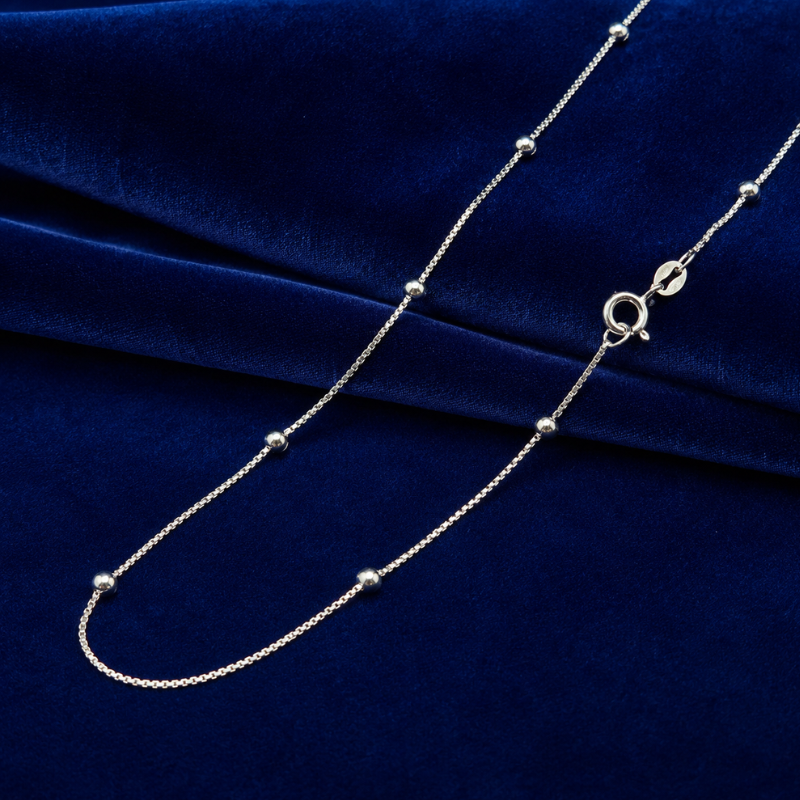 Stylish silver chain for ladies displayed on blue velvet