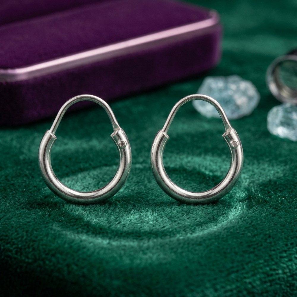 Woman wearing small pure chandi hoop earrings plain polished everyday wear Pakistan