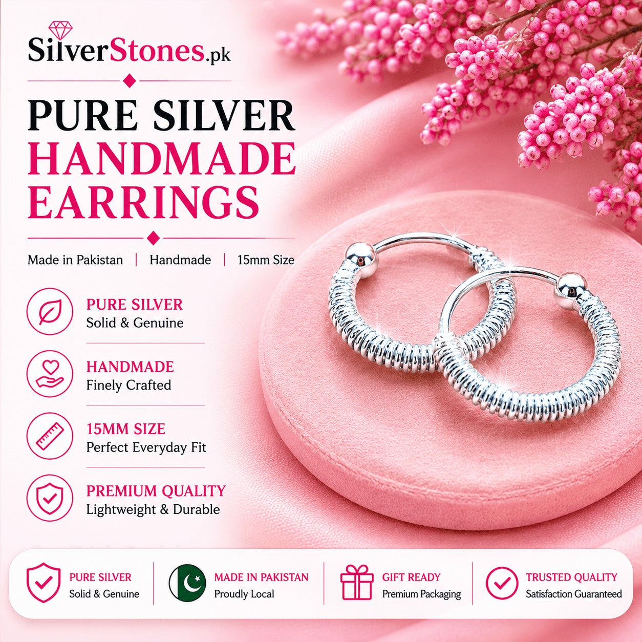 SilverStones.Pk 15mm handmade twisted pure silver hoop earrings with a textured finish on a pink display stand.