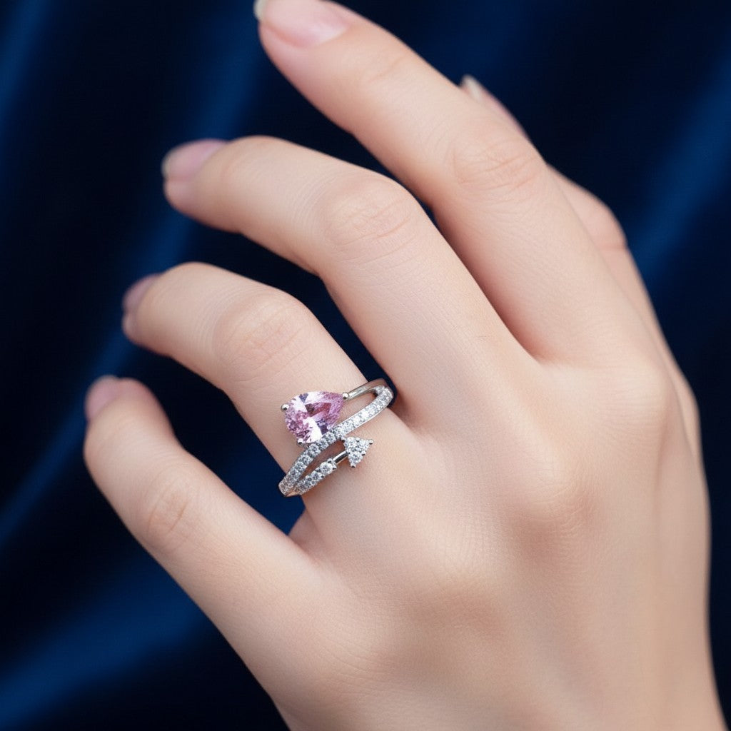 SilverStones.Pk 925 Italian silver ring with pink pear-cut zircon and small clear zircons.