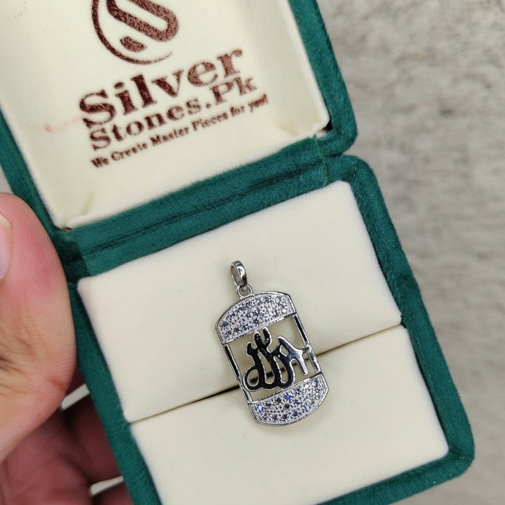 SilverStones.Pk 925 sterling silver pendant featuring the Arabic word for Allah, adorned with small clear crystals. Rectangular tag design.