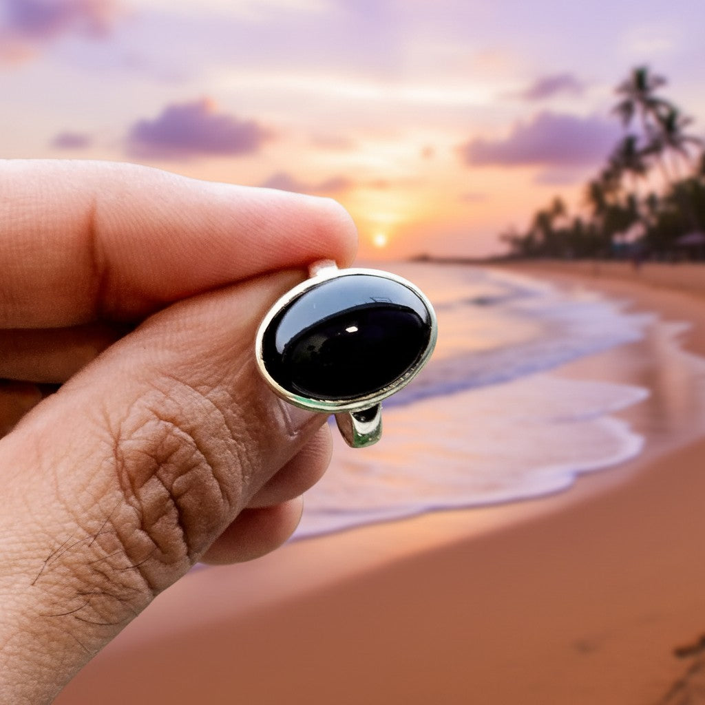 SilverStones.Pk oval black aqeeq gemstone ring on a finger, handmade silver chandi band.