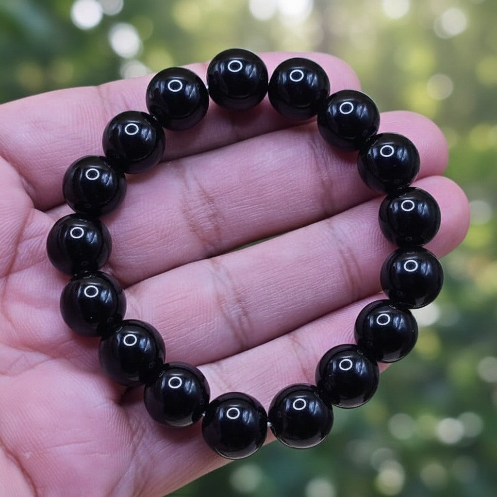 SilverStones.Pk black real aqeeq stone beaded bracelet with a polished finish.
