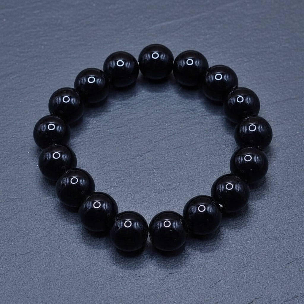 SilverStones.Pk black real aqeeq stone beaded bracelet with elastic band. Versatile elegance for any occasion.