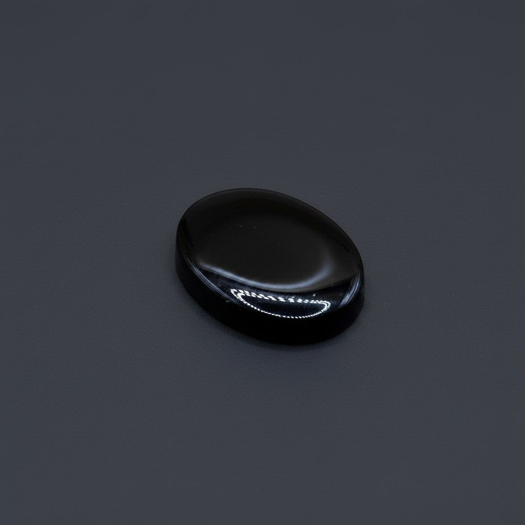 SilverStones.Pk oval black irani aqeeq stone, polished with natural banding, ideal for spiritual jewelry.