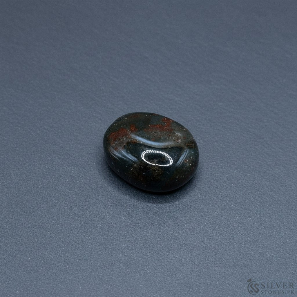 SilverStones.Pk real bloodstone gemstone with green and red inclusions, oval shape, polished finish.