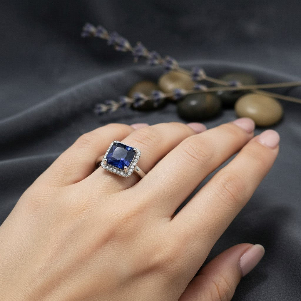 SilverStones.Pk A+ quality imitation ring with a large square blue zircon center stone surrounded by small clear zircon stones.