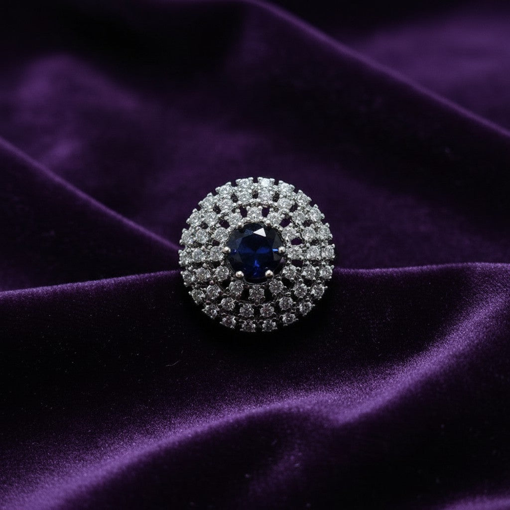 SilverStones.Pk A+ quality imitation ring with a central deep blue zircon stone surrounded by small clear zircon stones, set in color silver.