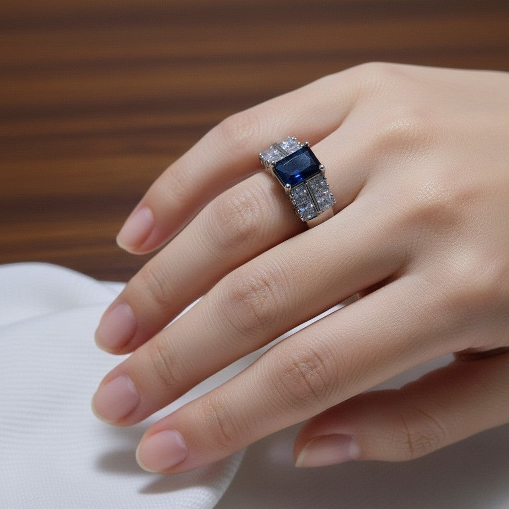 SilverStones.Pk elegant ladies ring with a central deep blue zircon and surrounding clear square zircons, crafted from color silver.